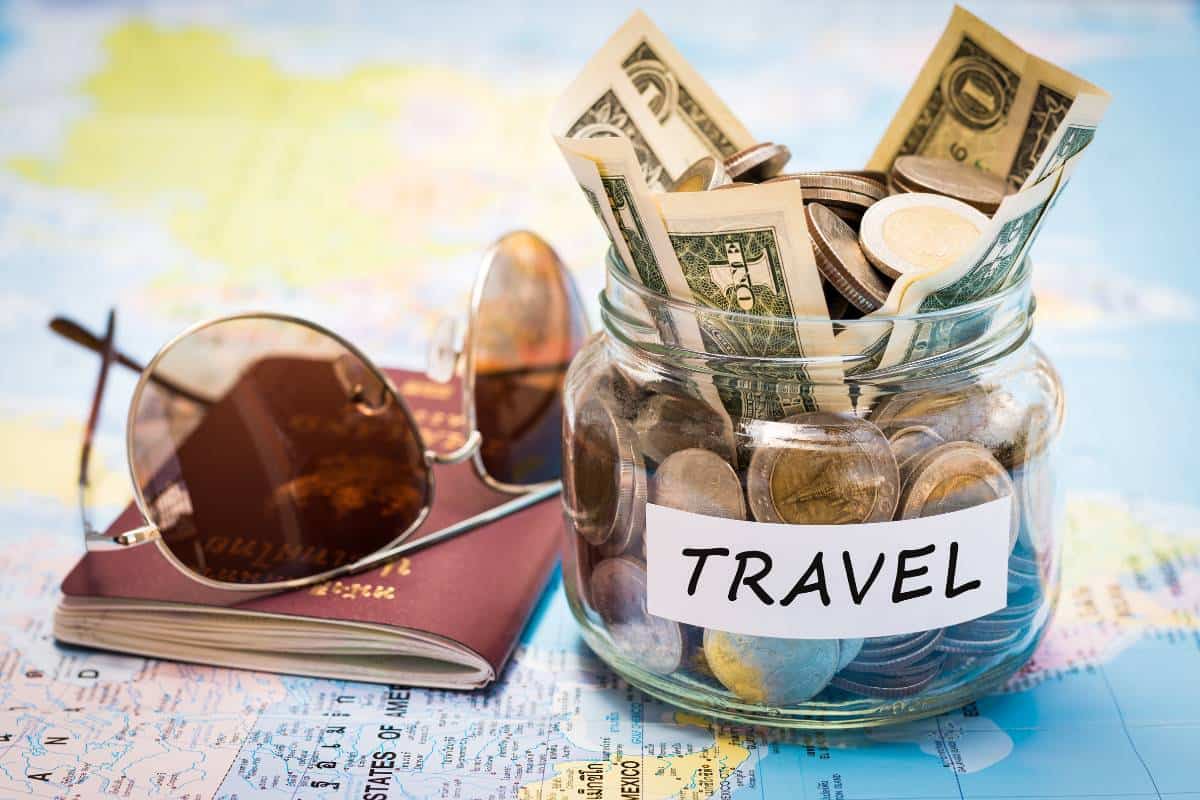 travel saving money jar on world map